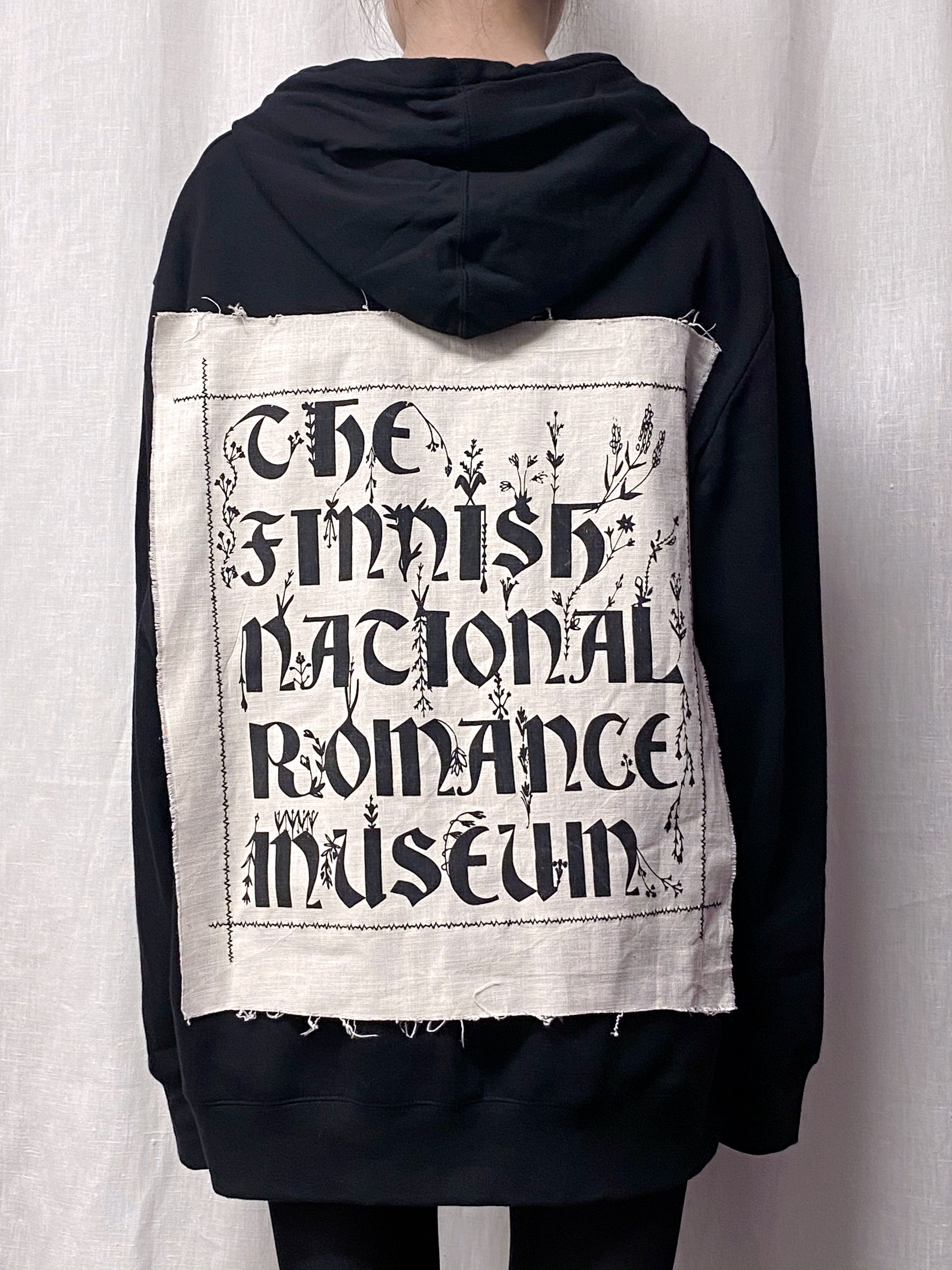 The Finnish National Romance Museum creates ready to wear pieces inspired by Finnish nature, history and culture. The FNRM Museo hoodie, black